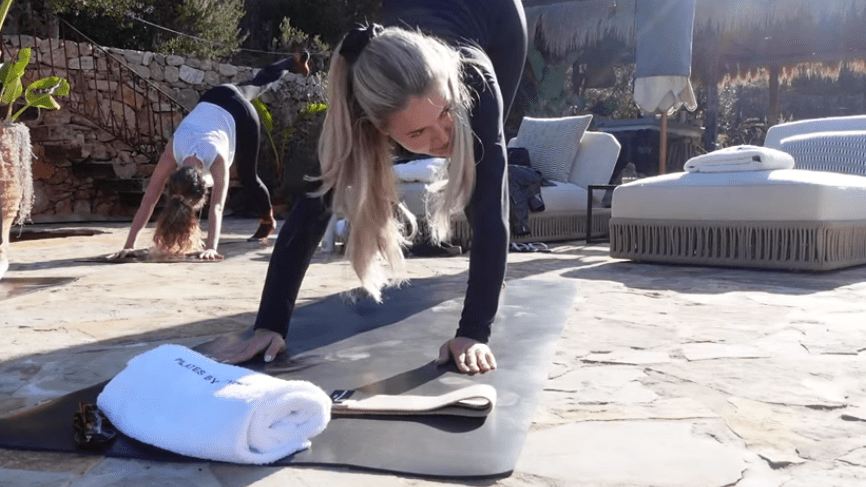 a yoga mat with a towel that says pure on it