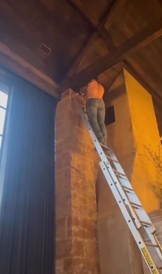 The former footballer was fixing a light at their Cotswolds mansion