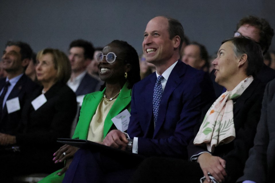 The Prince of Wales laughs in the audience during the event