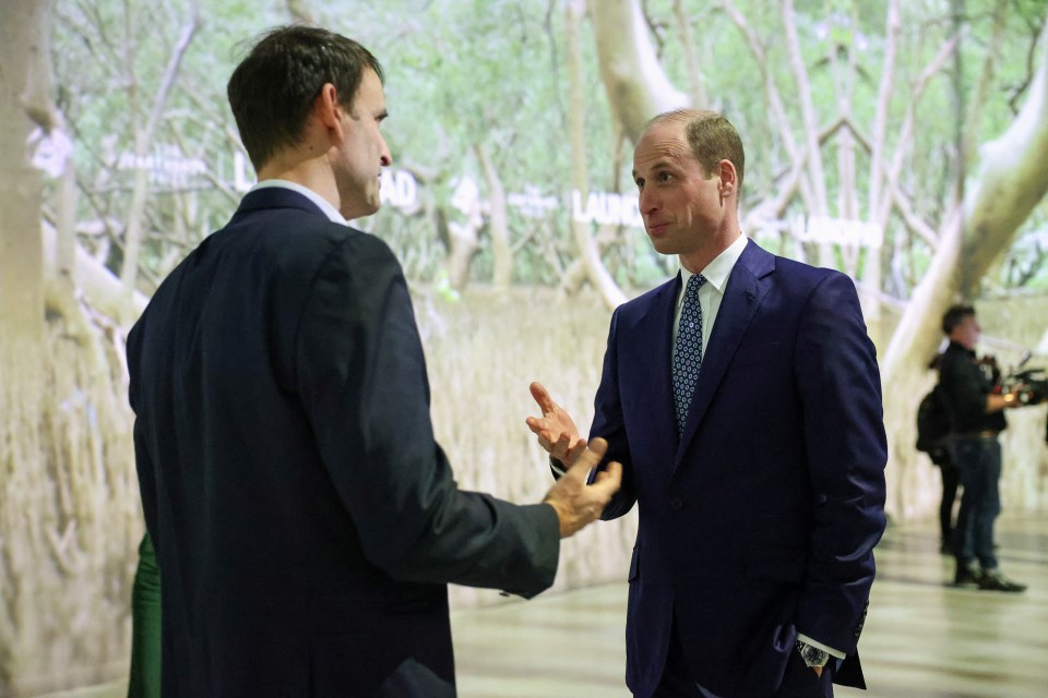 William, 41, speaks with an attendee at the inauguration of Launchpad