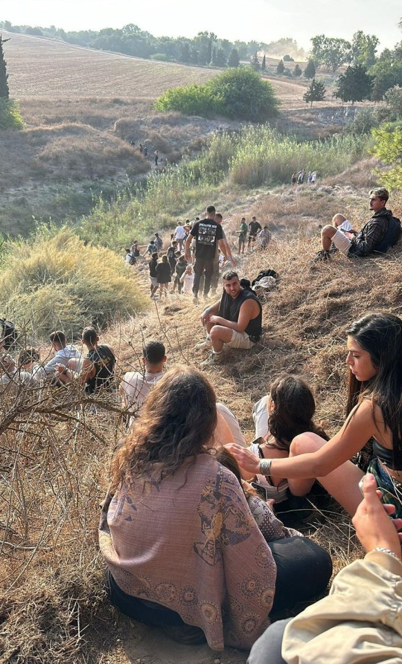 Festival-goers hiding after watching their friends be slaughtered by Hamas in the massacre