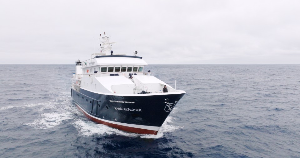 Chris Brown, 62, at the front of the Hanse explorer on his voyage to Point Nemo