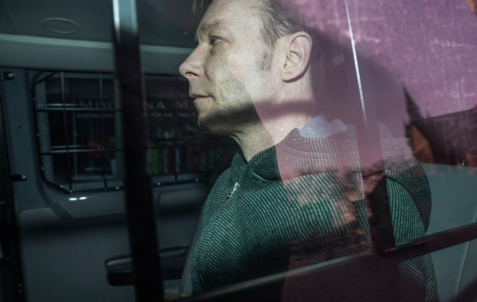 Brueckner arriving at court in a barred police van