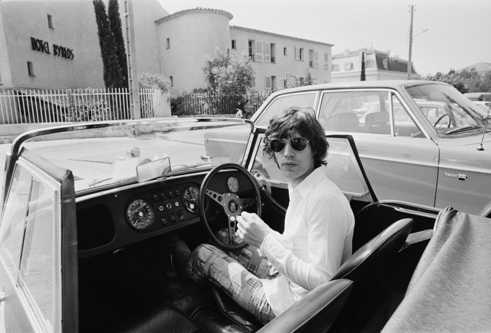 Mick Jagger at the wheel of his Morgan Plus 8 Roadster, outside the Hotel Byblos in Saint-Tropez