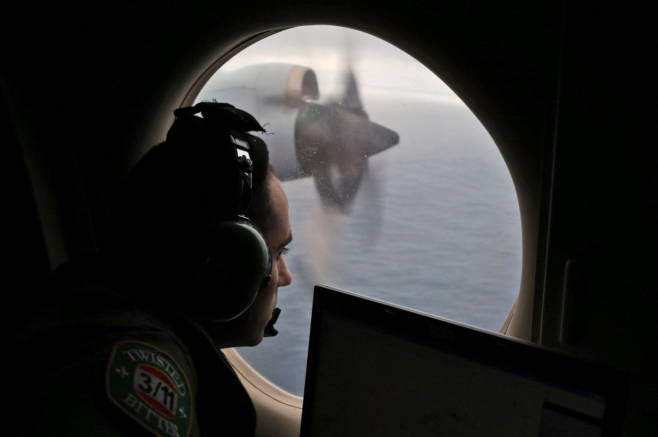 A Royal Australian Air Force officer scanning for the wreckage on March 22, 2014