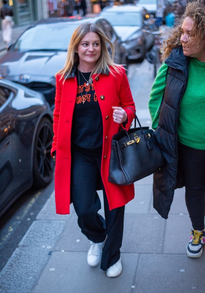 The star looked stylish in a bold red jacket and slogan t-shirt