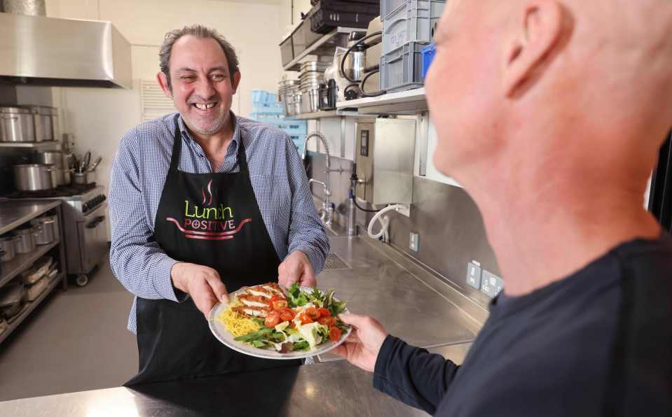 FareShare lunch positive director and cook Gary Pargeter serves redistributed KFC chicken