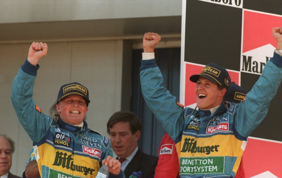 Herbert celebrates a podium finish with Michael Schumacher in 1995