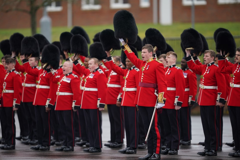 Irish Guardsmen lift their headwear to give Kate three cheers during a St Patrick's Day parade