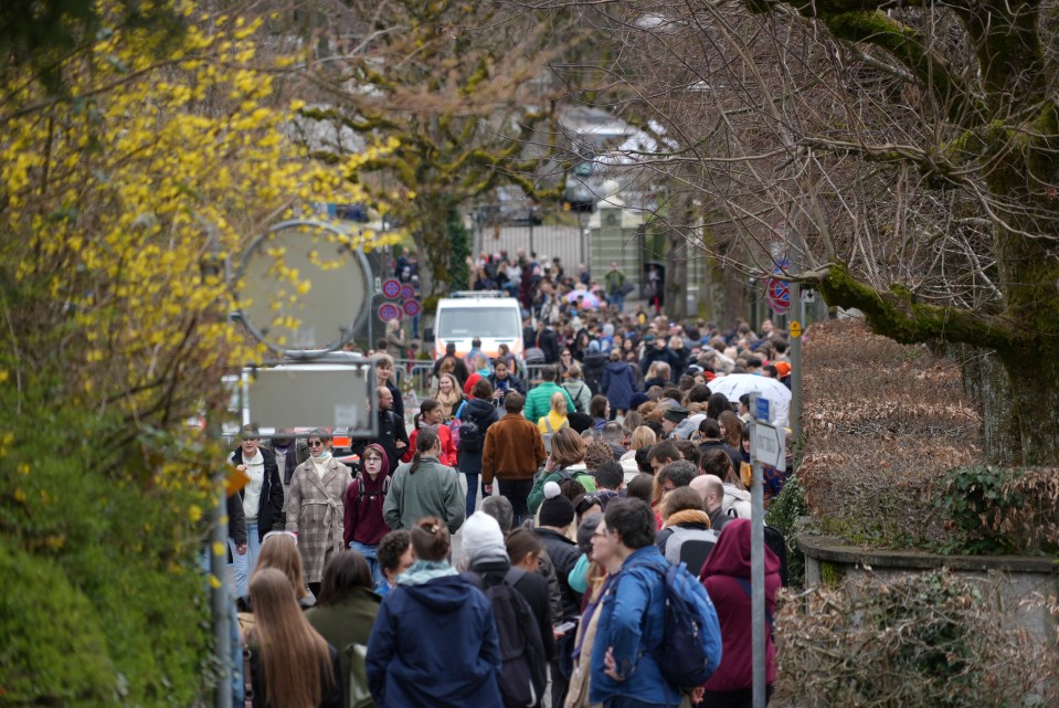 Russians living in Switzerland queue in front of the Russian embassy to vote