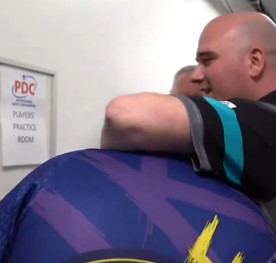 Rob Cross put Luke Littler into a playful headlock