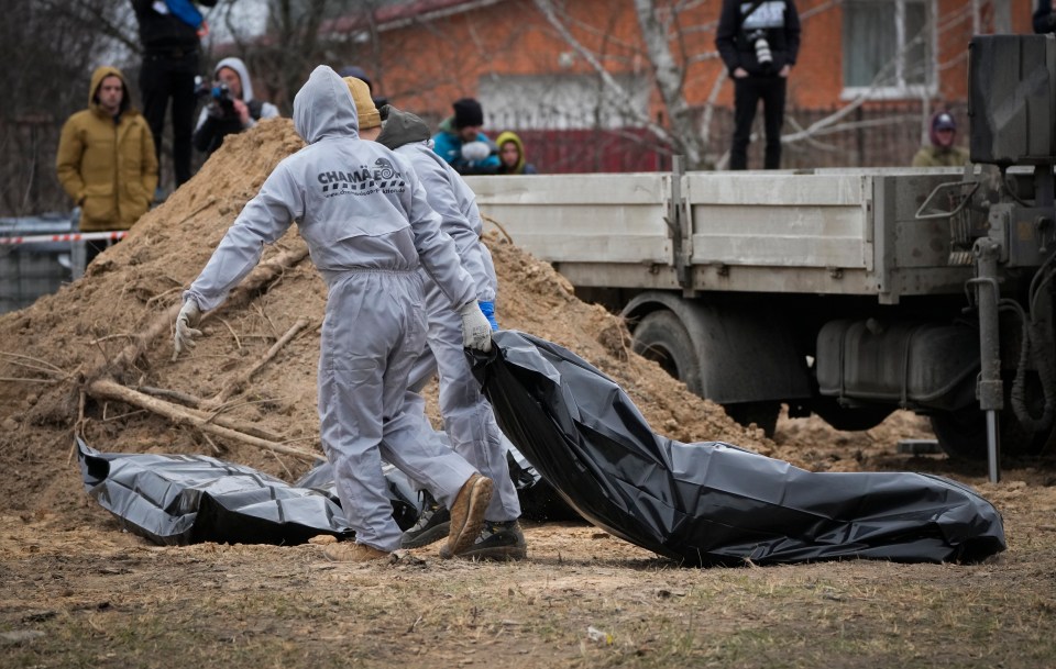 Bodies are removed from Russian-built mass graves to be identified