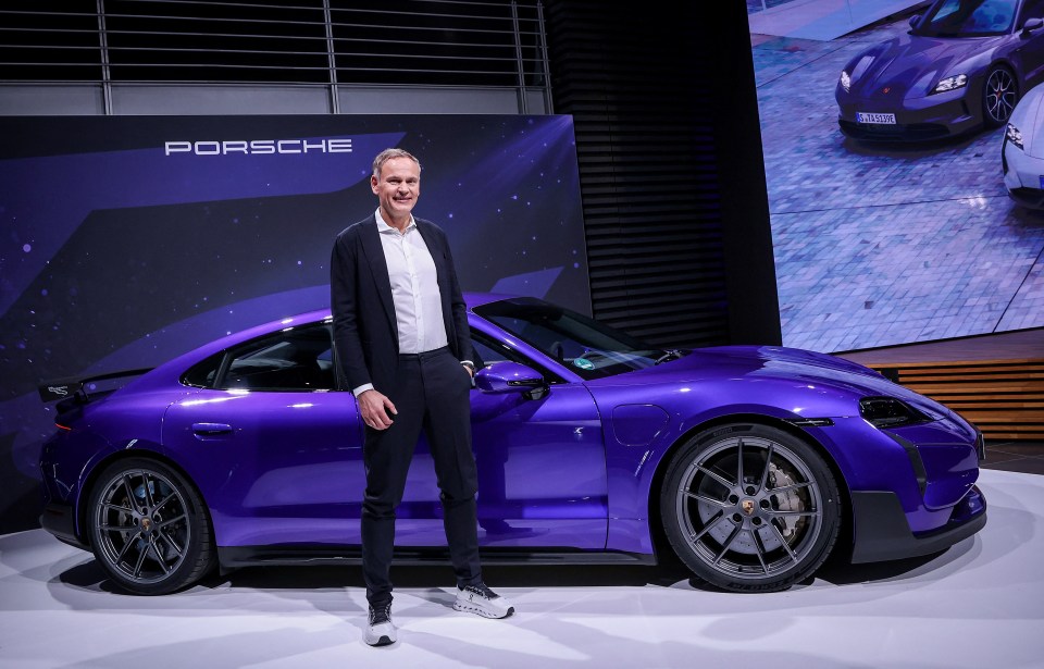 Oliver Blume, CEO of German car maker Porsche AG, poses next to the brand's newest super car