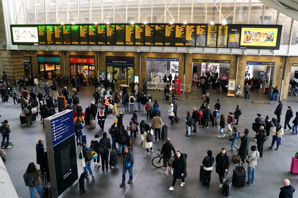 Passengers waiting for trains at London King’s Cross Station