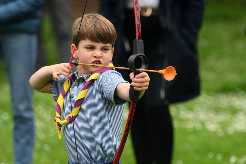 Prince Louis tries his hand at archery while taking part in the Big Help Out, during a visit to the 3rd Upton Scouts Hut in Slough, west of London on May 8, 2023