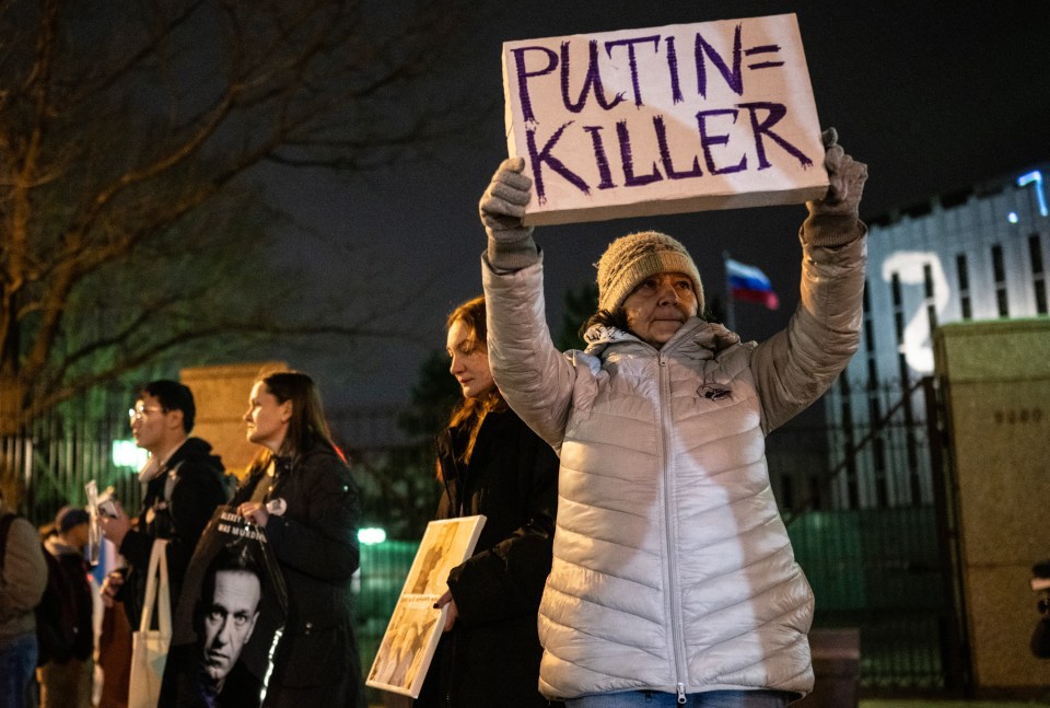 A woman holding a sign accusing Putin of being a killer during a protest in Washington DC