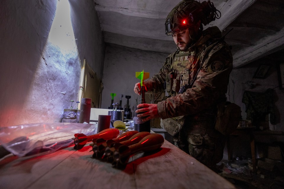 A Ukrainian solider prepares bombs to load on Vampires