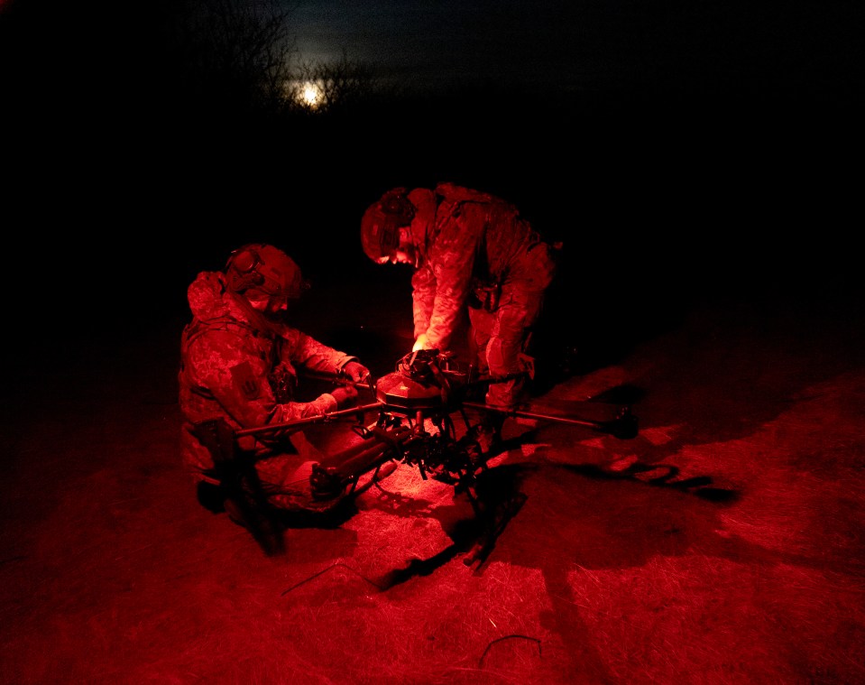 In the fields outside they work by red torchlight to stay hidden from Russian spotters