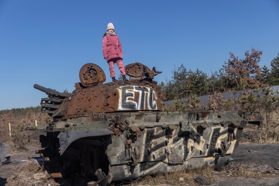 Children  play on a destroyed Russian tank near Bucha