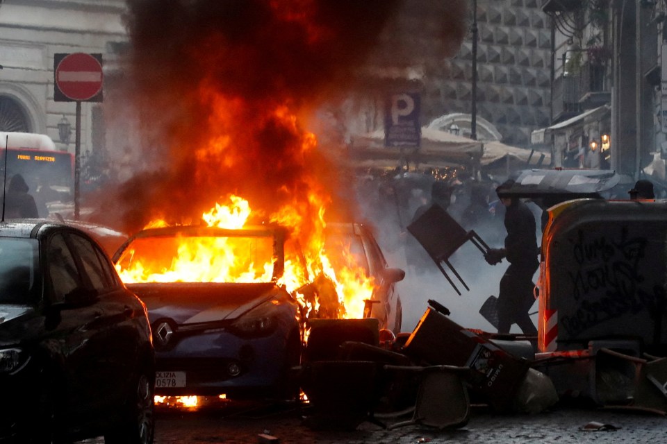 A police car was set on fire by rioting Eintracht Frankfurt fans in Naples