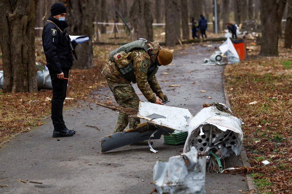 Police officers inspect a part of a Russian Kh-55 cruise missile in Kyiv