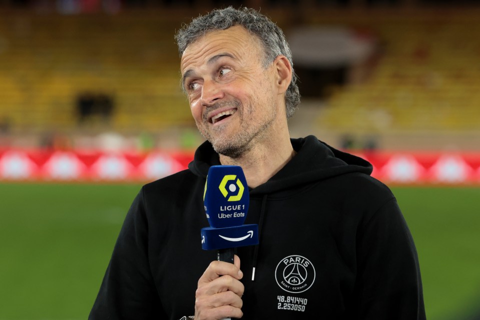 Luis Enrique speaks into a microphone emblazoned with the Ligue 1 Uber Eats logo