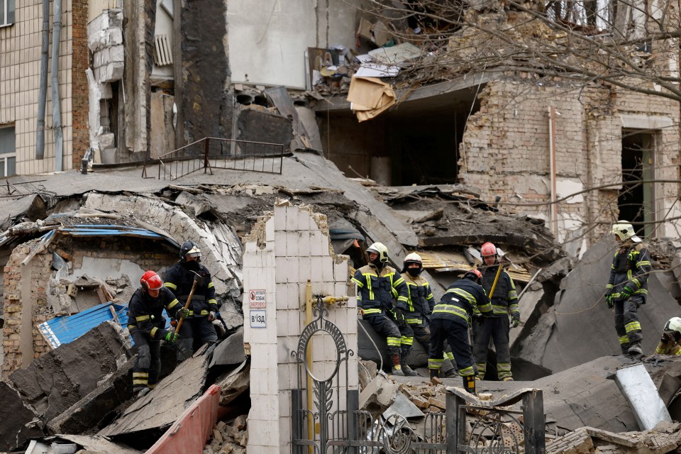 Ukrainian rescuers working on the site of a damaged building after the attack