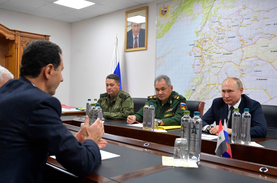 Gen. Aleksandr Chaiko (back left) - who was in charge of the atrocities in Bucha and other suburbs of Kyiv - sits next to Russia's Minister of Defence Gen. Sergei Shoigu and Putin as they face Syrian dictator Bashar al-Assad in 2020