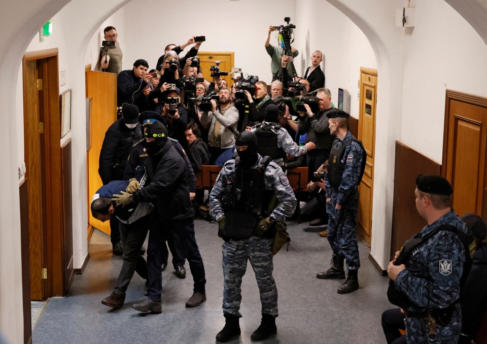 Rachabalizoda being escorted into court – where he pleaded guilty to a charge of terrorism