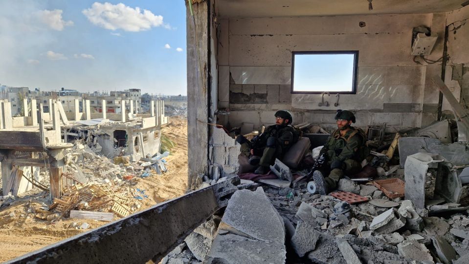 Sam and a fellow soldier inside the ruins of a residential building in the Gaza Strip