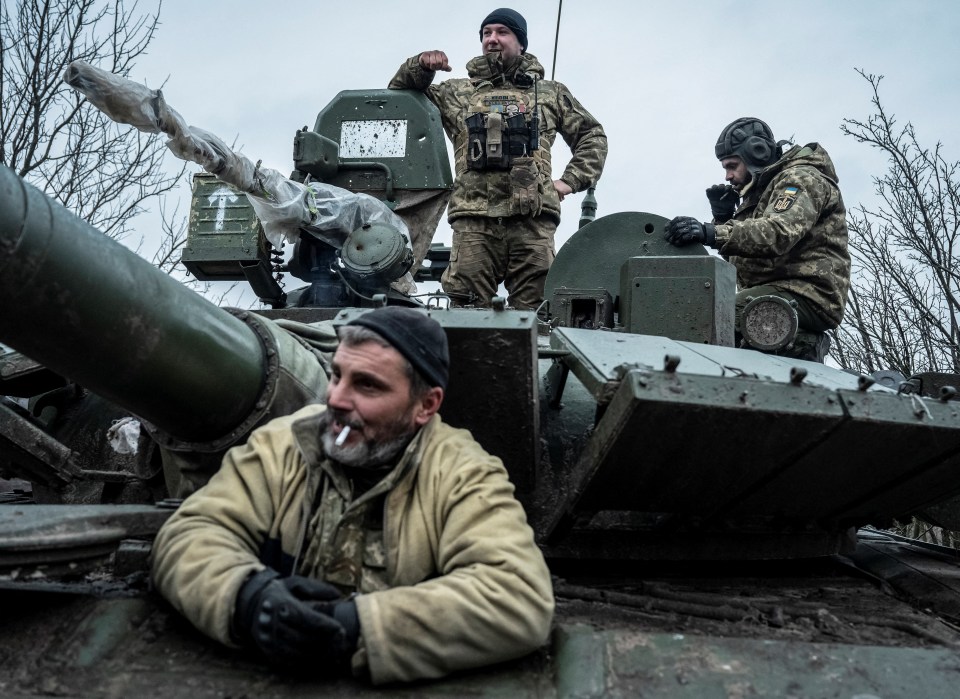 Servicemen of the Carpathian Sich Battalion are seen on a tank on a frontline, near the town of Liman, in December 2022