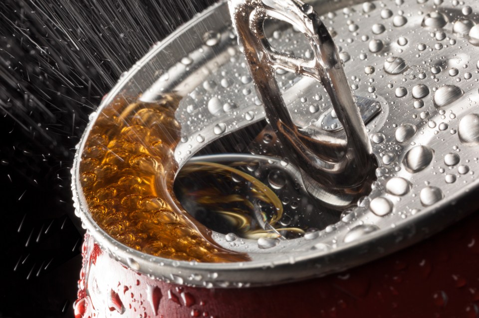 a close up of a soda can with water drops on it