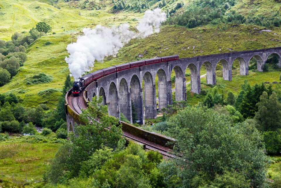 The steam train crosses Glenfinnan Viaduct on its way from Fort William to Mallaig