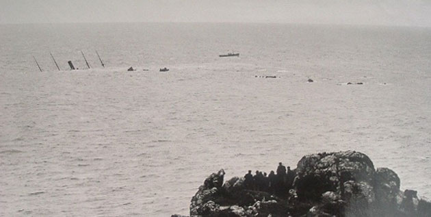 The S.S. Mohegan with just her masts and funnel visible on the Manacles