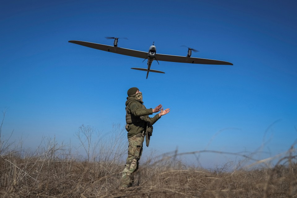 A Ukrainian serviceman launching a drone in Bakhmut on March 12