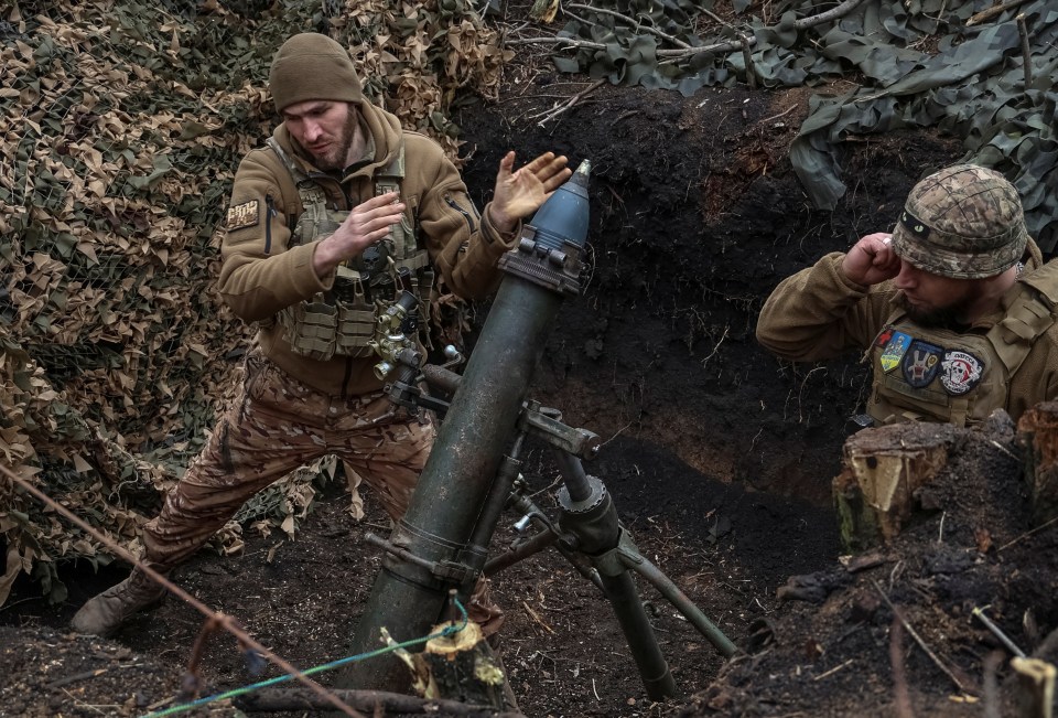 Ukrainian servicemen firing a 120-mm mortar towards Russian troops in Bakhmut on March 15