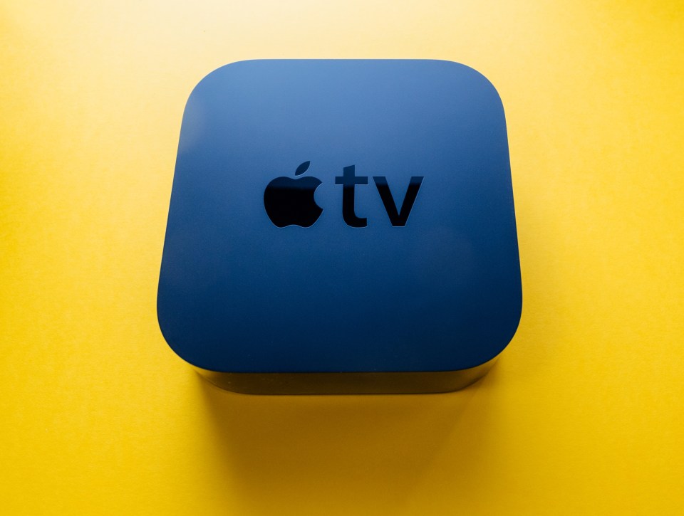 a blue apple tv box on a yellow background