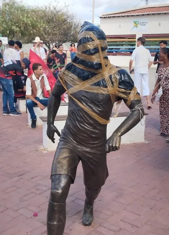 A Dani Alves statue wrapped in duct tape and bin bags after furious locals demanded it to be removed following the Brazilian's conviction