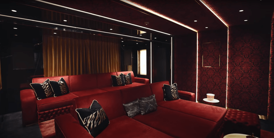 The plush red velvet-clad cinema room with a 102-inch OLED screen