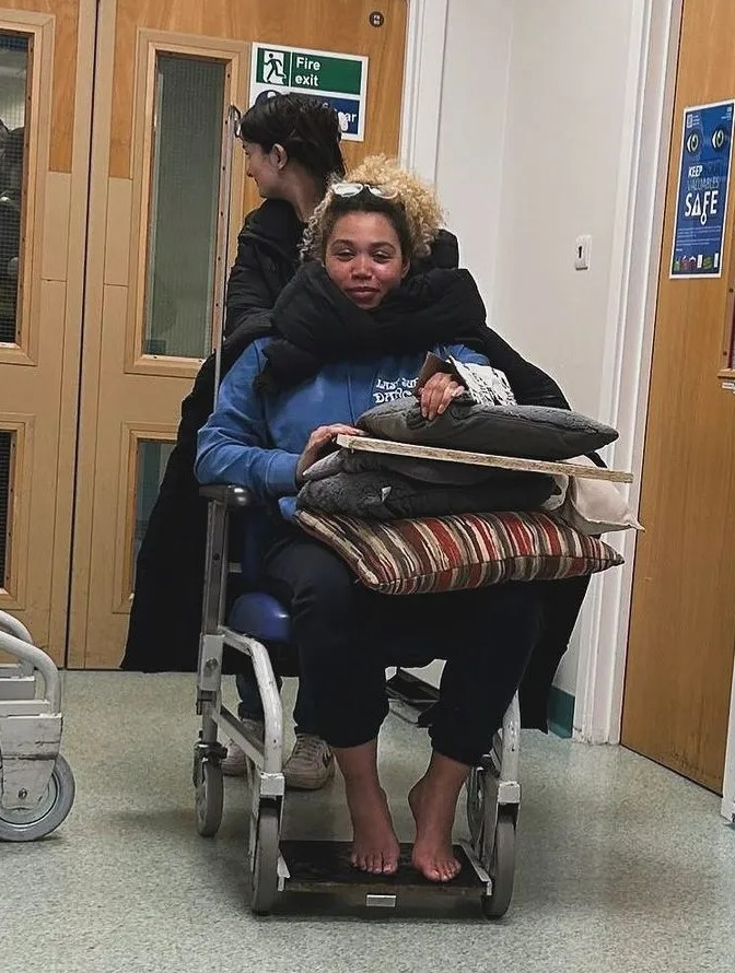 She was then seen being wheeled around in the hospital with her left arm propped up