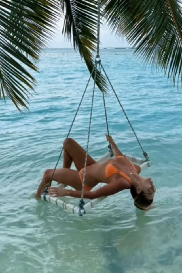 BGT judge Amanda Holden looked sensational as she stripped to an orange bikini as she stretched back on a hammock