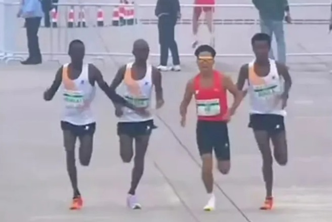 Chinese athlete He Jie was allowed to cross the line in first place