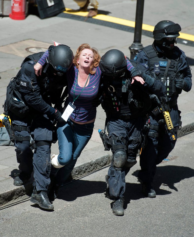 MET police officers and a participant during a mock terrorist attack exercise on a London tube station, June 2015