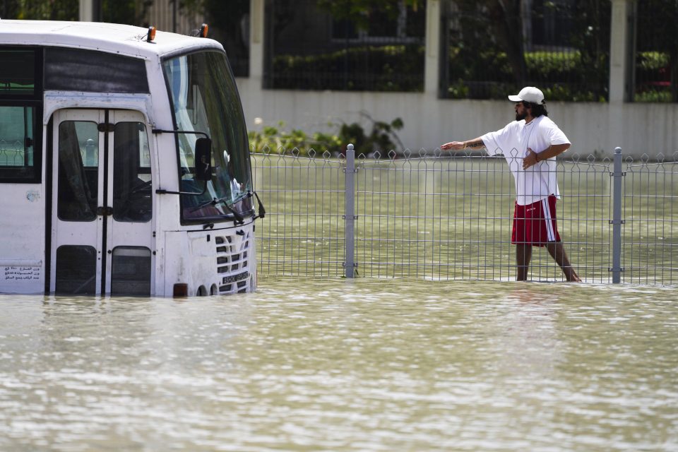 A man walks through floodwater in Dubai on Wednesday after huge downpours