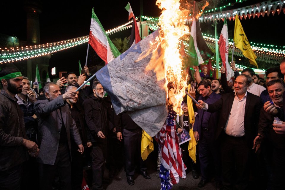 Iranian protesters burn US and Israeli flags in Tehran