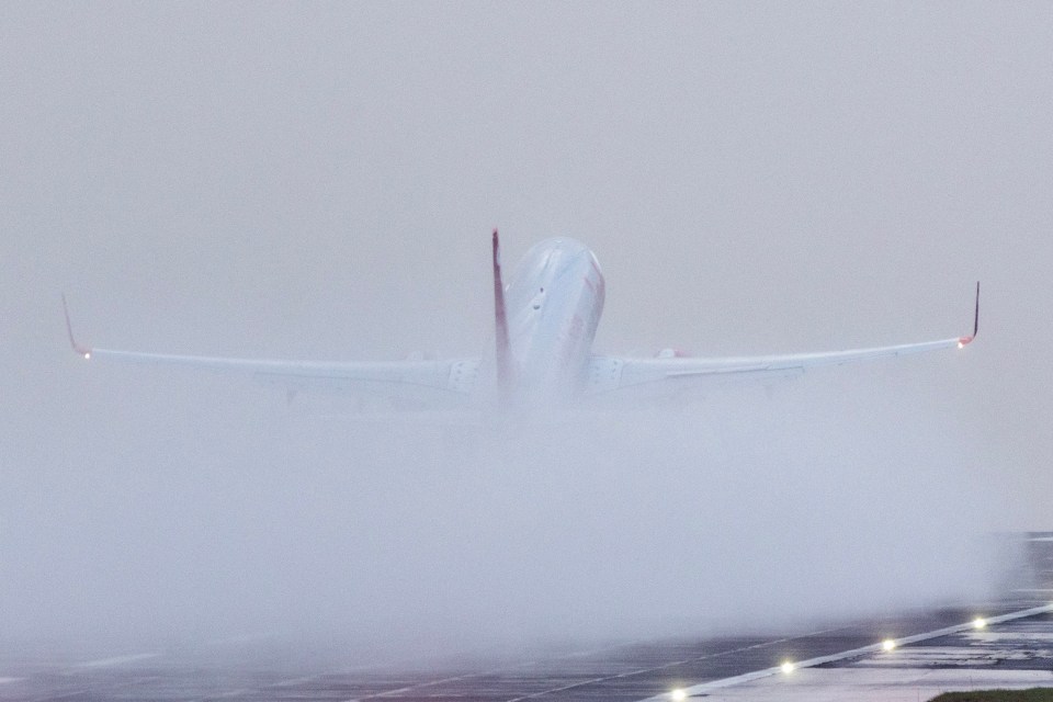 A Jet2 aircraft takes off in the pouring rain this morning at Leeds Bradford airport