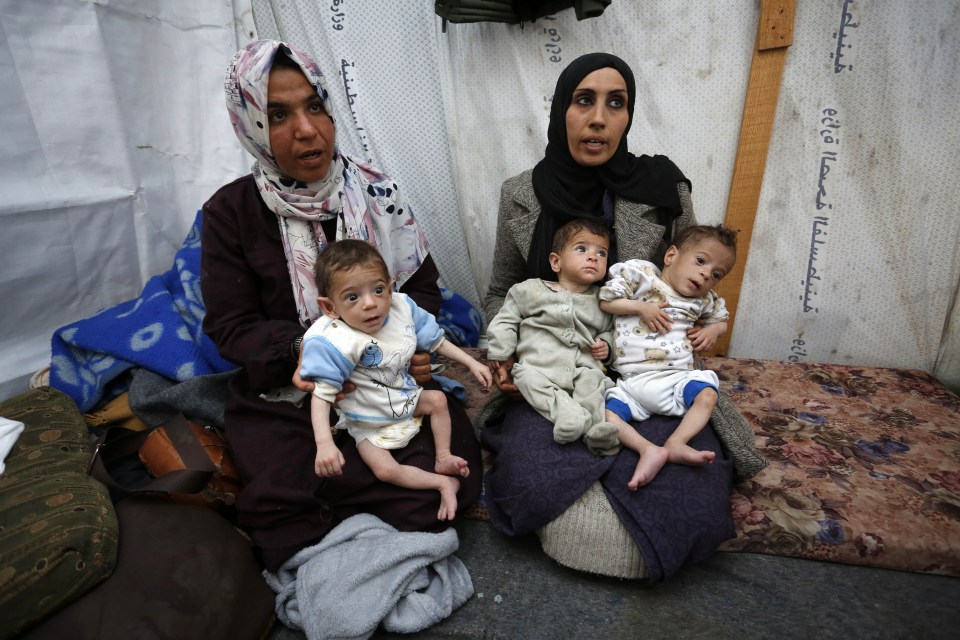 Palestinian triplets suffering severe malnutrition in Nuseirat camp, Gaza on March 25