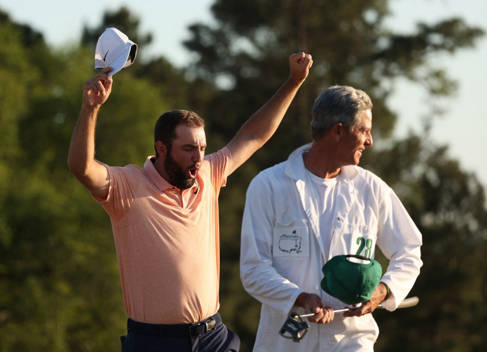 World No1 Scheffler raises his arms in victory on the 18th