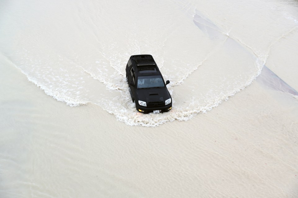 Motorists drive during heavy rainfall in Dubai on Tuesday