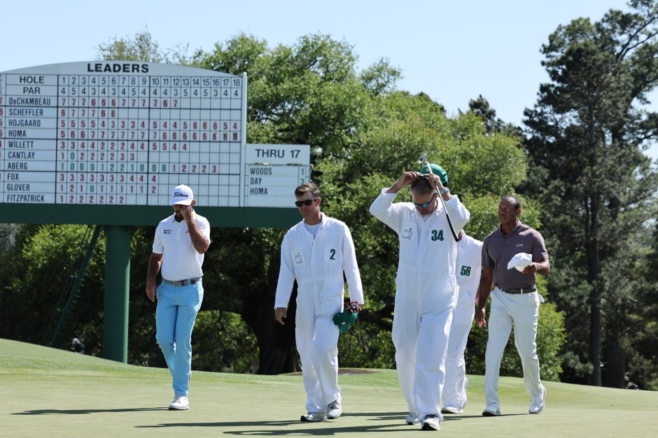 Homa, extreme left, and Woods, far right, walk off after the second round